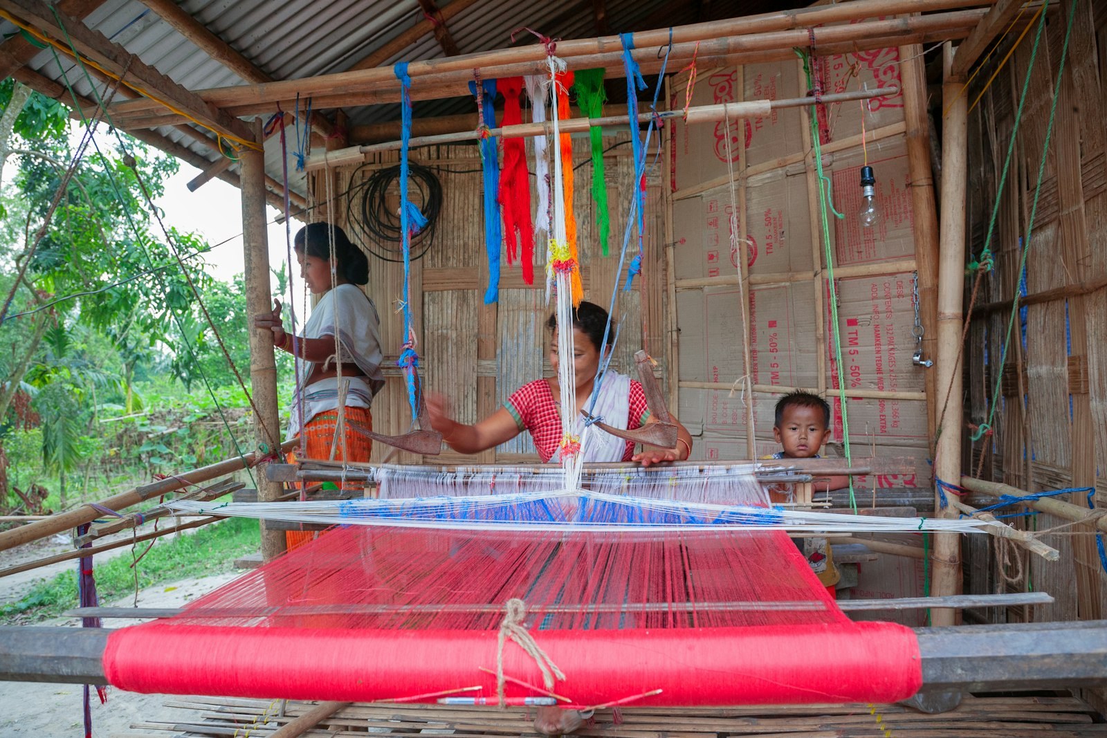 Women weaving together on a handloom